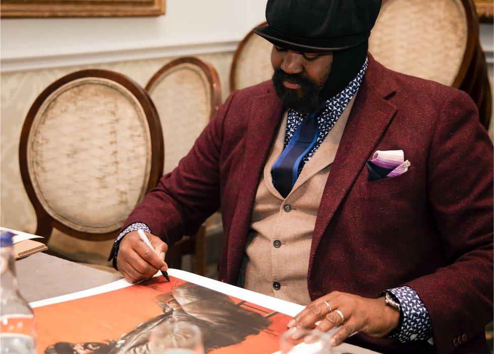 Gregory Porter signing a print