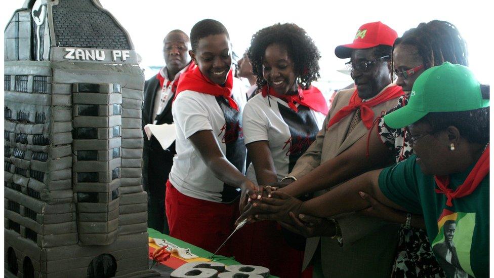 Zimbabwe's President Robert Mugabe (3rd R) cuts his birthday cake with the first family, his children Chatunga Mugabe (2nd L) and Bona Mugabe (C) and his wife Grace Mugabe (2nd R) during a 21st February Movement celebrations rally held in honor of his 89th birthday at Chipadze stadium in Bindura on March 2, 2013