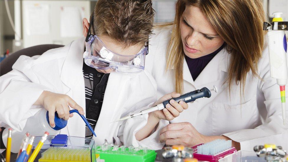 Teacher with child in lab