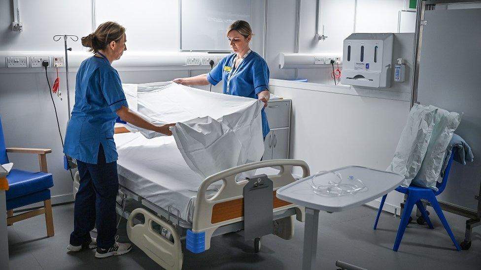 Nurses making bed