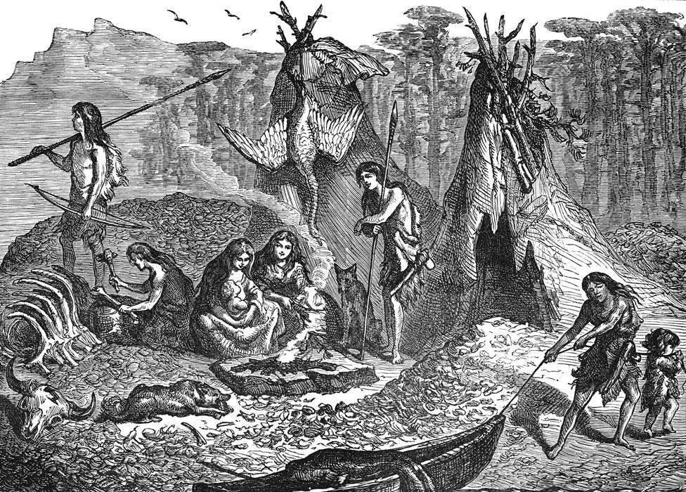 A 19th Century illustration showing a group of hunter gatherers around a fire