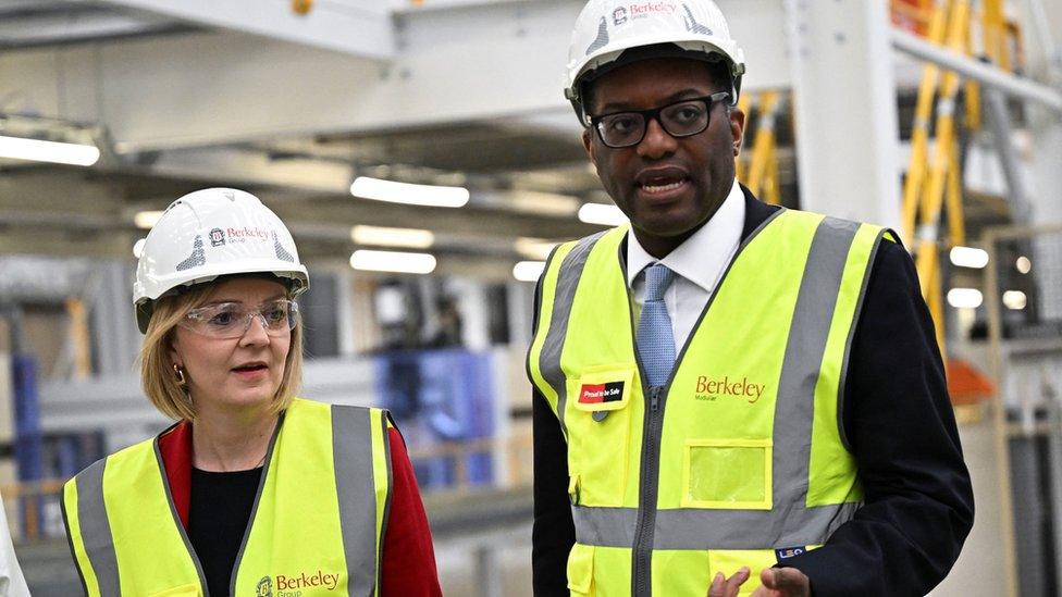 Prime Minister Liz Truss and Chancellor Kwasi Kwarteng seen wearing hard hats and high vis jackets during a visit to a factory