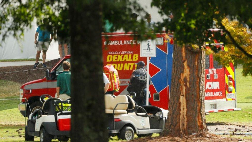 Emergency services provide assistance next to a tree damaged by a lightning strike at East Lake Golf Club on 2 August 2019 in Atlanta, Georgia