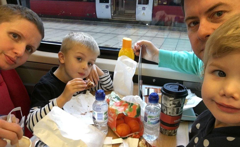 Wilson family sitting at a table on a train