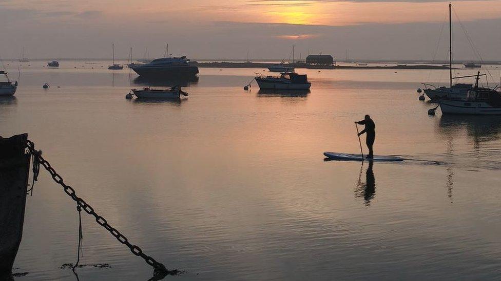 Packing Shed Island, boats and a paddle boarder