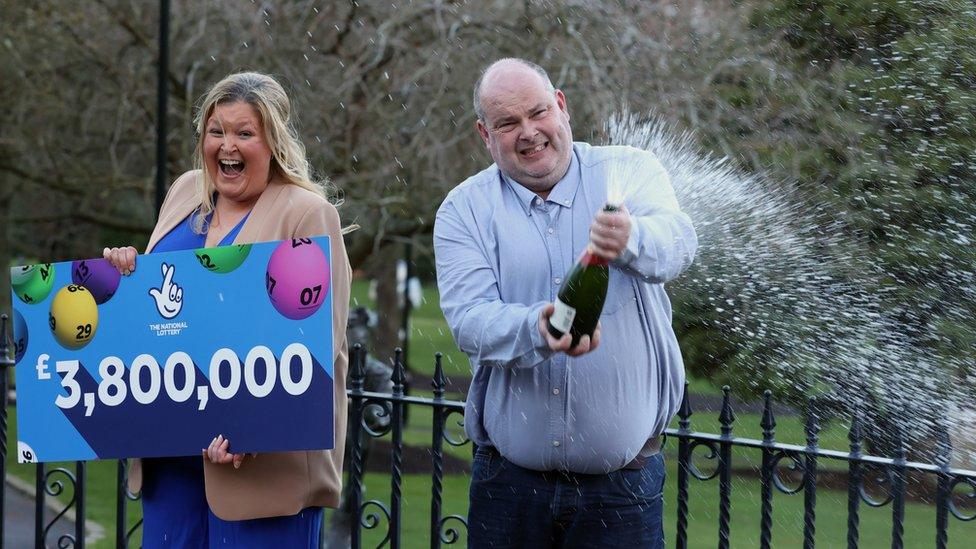 Jonny Johnston and Christina Williams spraying champagne