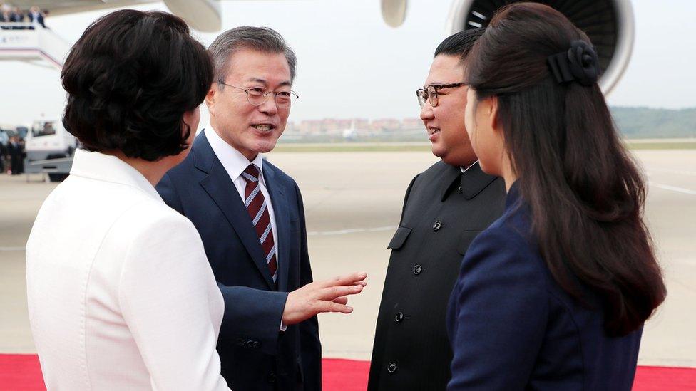 Kim Jung-sook, Ri Sol-ju, Moon Jae-in and Kim Jong-un embrace at the airport