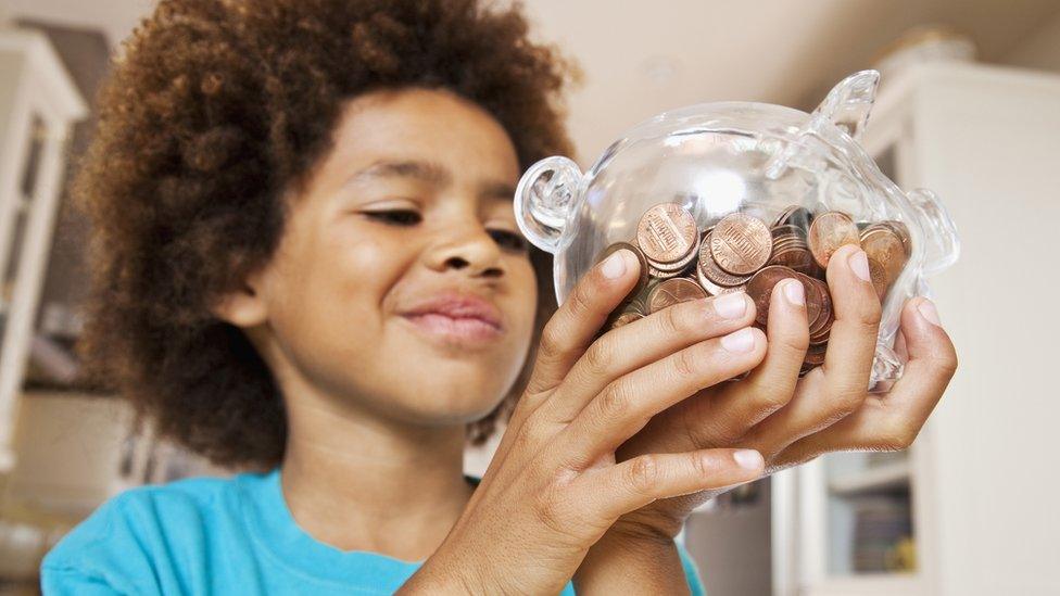 boy holding a piggy bank