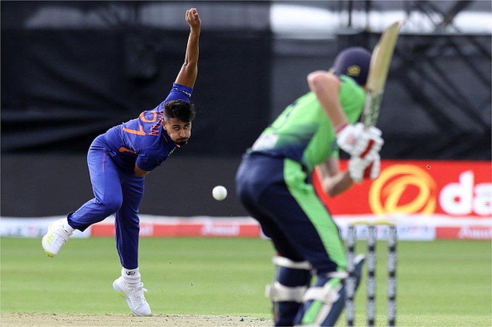 India's Umran Malik (L) bowls during the Twenty20 International cricket match between Ireland and India at Malahide cricket club, in Dublin on June 26, 2022.