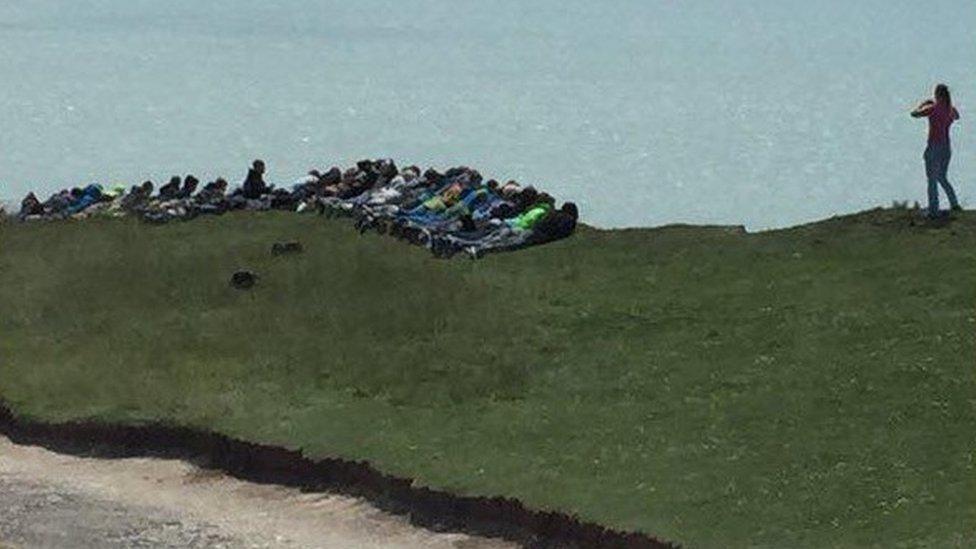 Students on cliff edge