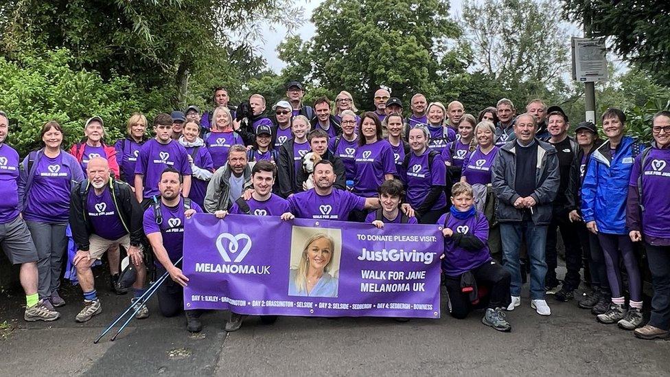 Walkers holding up a banner