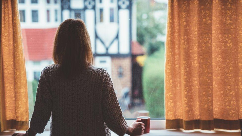 Woman gazing out of a window