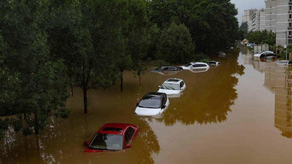 Cars are immersed in flood water in a neighbourhood where days of heavy rain from remnants of Typhoon Doksuri have caused heavy damage in Beijing, China, August 1, 2023.