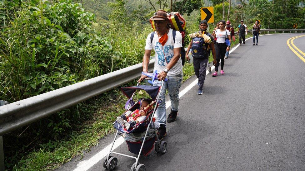 Jan Pinero and his family walk along the road between Cucuta and Pamplona on Wednesday 30 September. Pinero was heading to Ecuador with his wife, a cousin, and three children ages 2, 4 and 16.