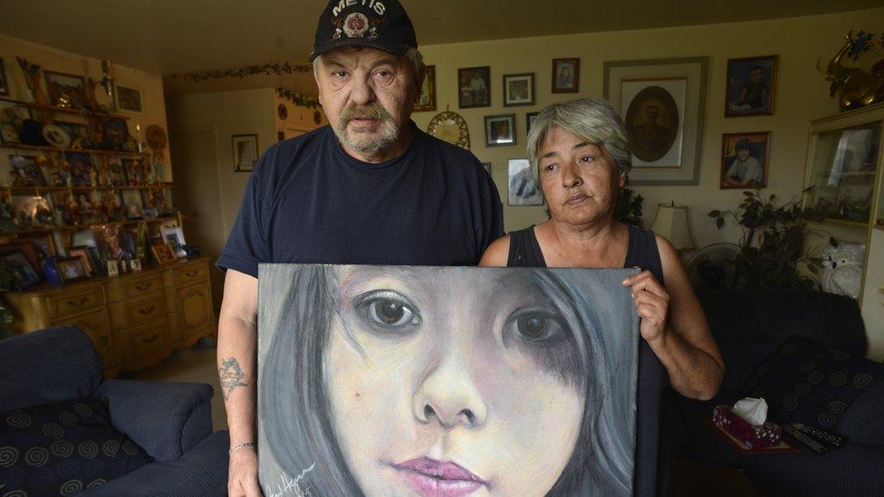 Joe and Thelma Favel display a framed painting of their niece, Tina Fontaine, who was murdered and dumped in the Red River