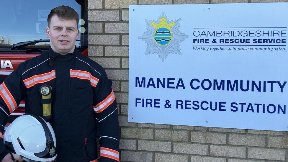 Firefighter next to sign