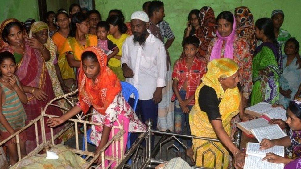 Bangladeshi relatives surround the bodies of some of those killed in a stampede