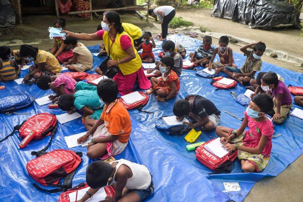 Children of a low-income neighbourhood attend open-air classes.