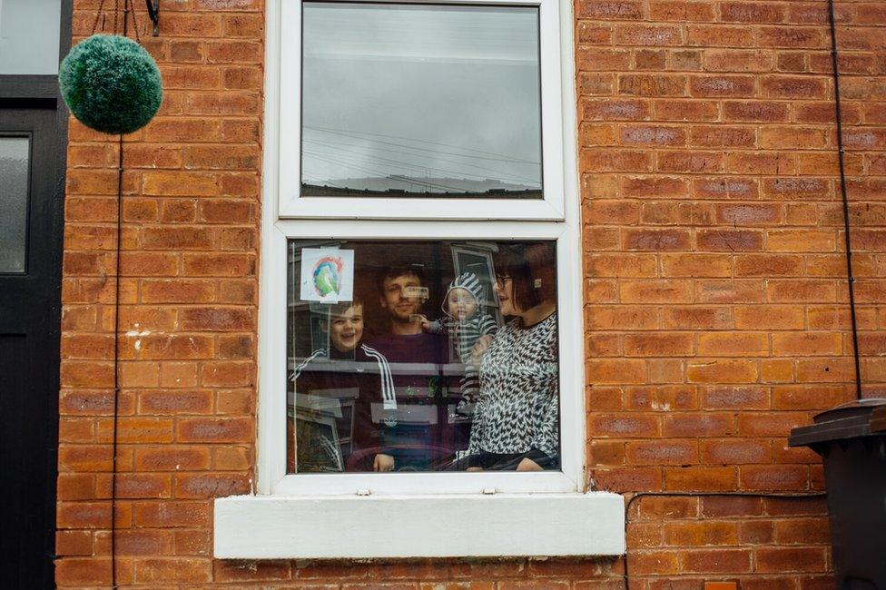 Doorstep portrait of Adam and Amy and their two children in Nether Edge