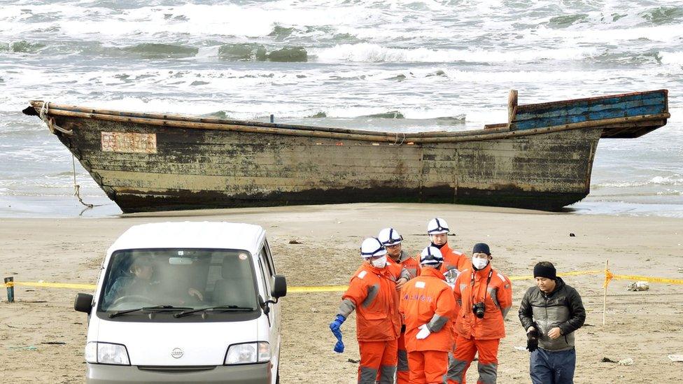 A wooden boat, which drifted ashore with eight partially skeletal bodies and was found by the Japan Coast Guard, is seen in Oga, Akita Prefecture, Japan, in this photo taken by Kyodo on 27 November 2017