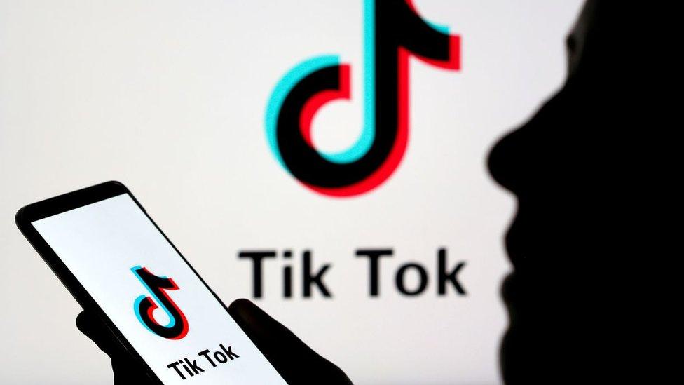 Tik Tok logo and person with phone using app