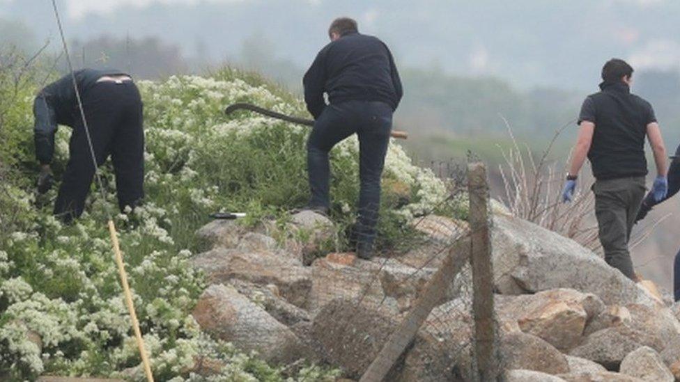 A garda search team at the harbour wall near Bray Boxing Club in County Wicklow