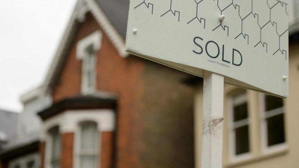 Houses and sold sign