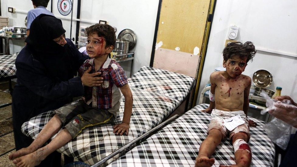 Syrian children wait for medical attention after an airstrike attack on Douma, outskirts of Damascus, Syria, 23 August 2016