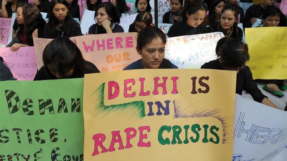 Women from India"s North Eastern states hold placards during a peaceful protest against the rape of a girl from Mizoram, in New Delhi on November 29, 2010.