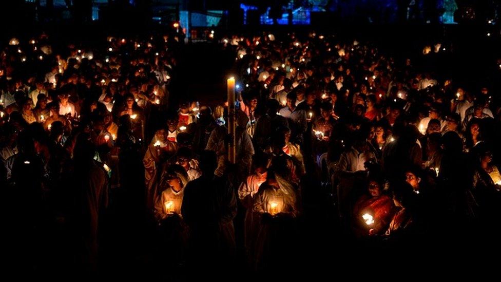 Worshippers lit candles at a midnight Easter Vigil Mass in Secunderabad, India