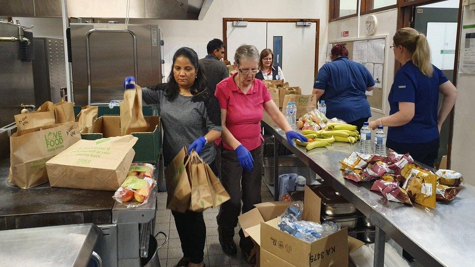 Volunteers making packed lunches for the trp