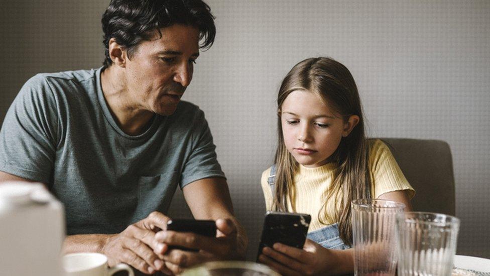 Child and parent on smartphone