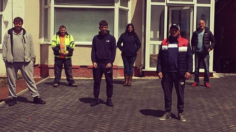 The workers that helped transform Mrs Elkiraa's (centre) driveway