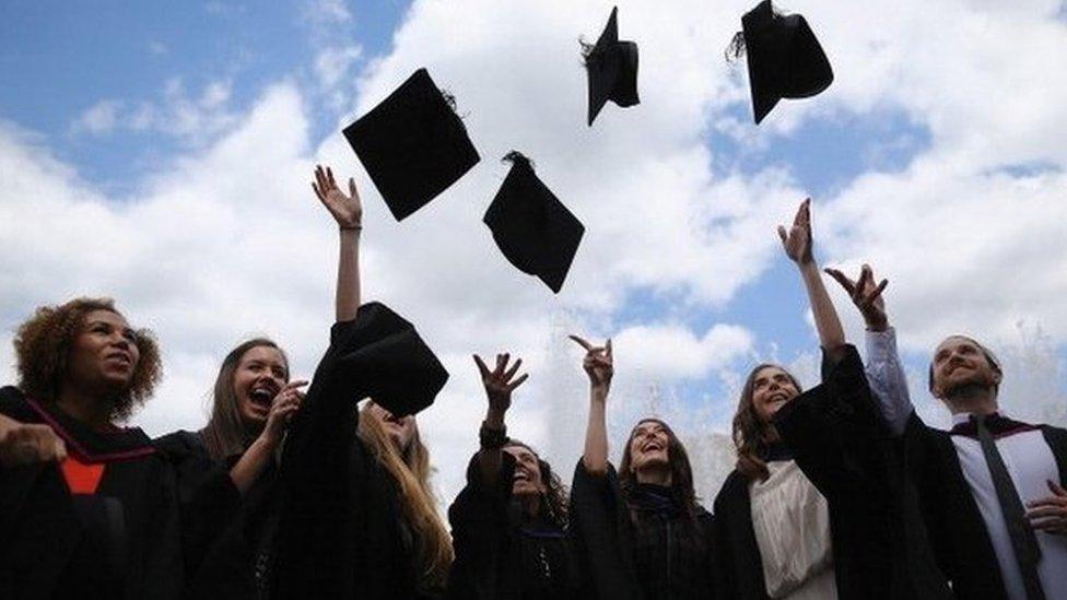 Graduates throwing their hats into the air