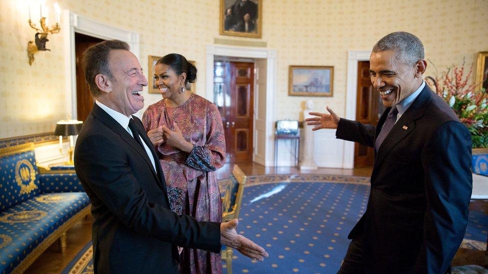 The president reaches out to shake hands with Bruce Springsteen in the Blue Room of the White House prior to the Presidential Medal of Freedom ceremony