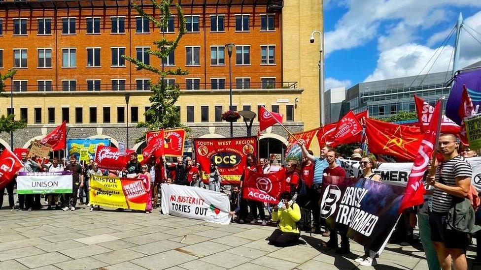 A crowd of people with banners in a city square