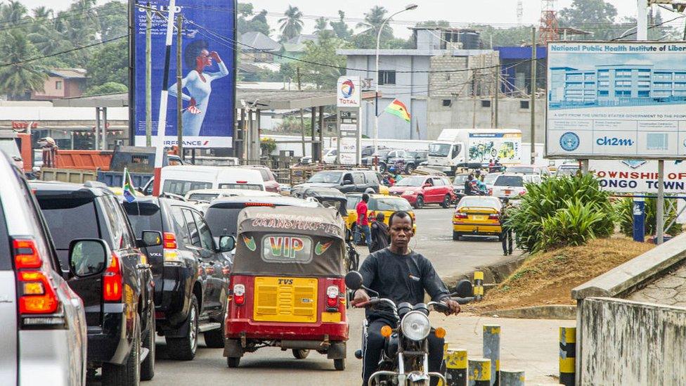 Cars and other vehicles on a street in Monrovia on February 14, 2022