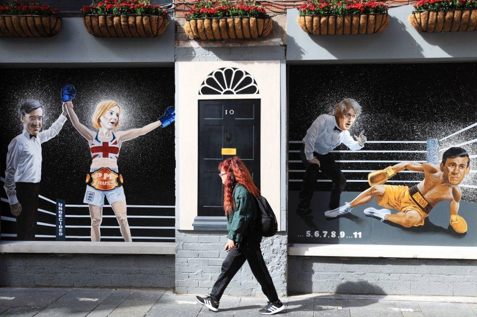 A mural in Belfast, depicting Liz Truss as a boxer who has won a fight - the mural features an illustration of Jacob Rees-Mogg, dressed as a referee, holding her arm aloft