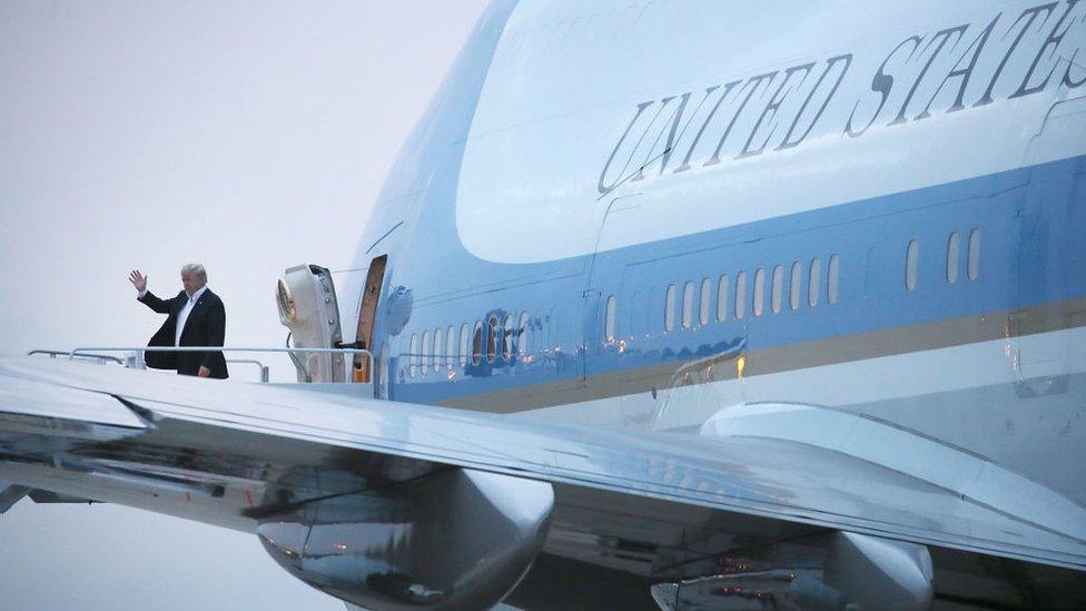 Trump emerges from Air Force One after landing in Washington