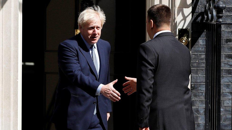 Boris Johnson shakes hands with Juri Ratas