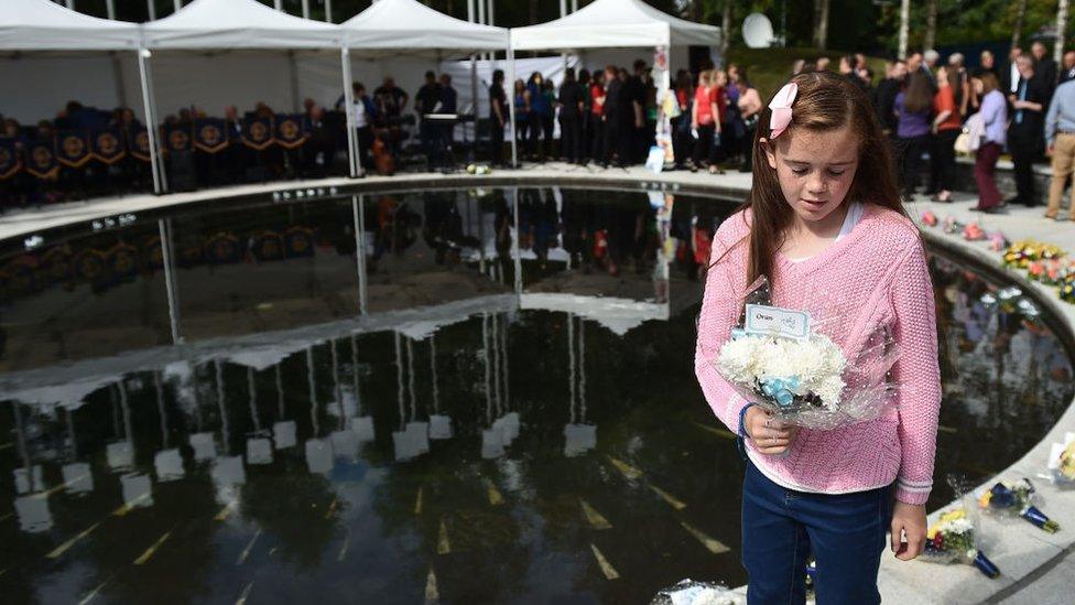 A-relative-lays-a-wreath-as-a-remembrance-service-takes-place-for-the-victims-of-the-Omagh-bombing-on-it's-20th-anniversary-on-August-12-2018