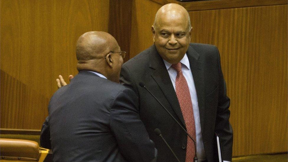 Finance Minister Pravin Gordhan shake hands with South African President Jacob Zuma in Parliament.