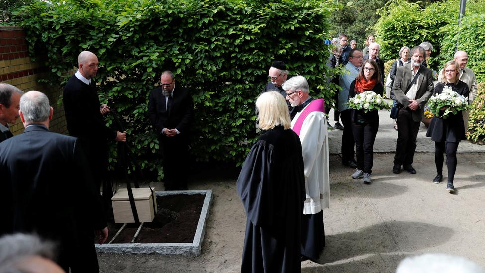 Mourners with coffin containing victims' tissue, 13 May 19