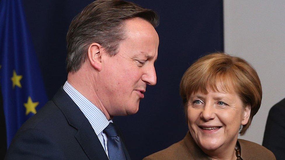 British PM David Cameron and German Chancellor Angela Merkel talk.