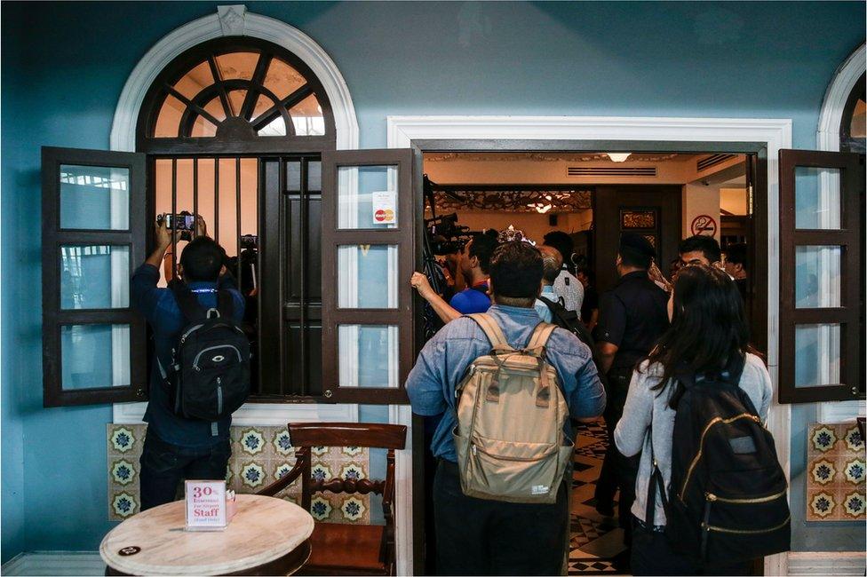 Media members react during a revisit to the scene of the assassination of Kim Jong-nam, the estranged half-brother of North Korea"s leader Kim Jong-un, by the suspects Siti Aisyah of Indonesia and Doan Thi Huong of Vietnam, at the Kuala Lumpur International Airport 2 in Sepang, Malaysia, 24 October 2017