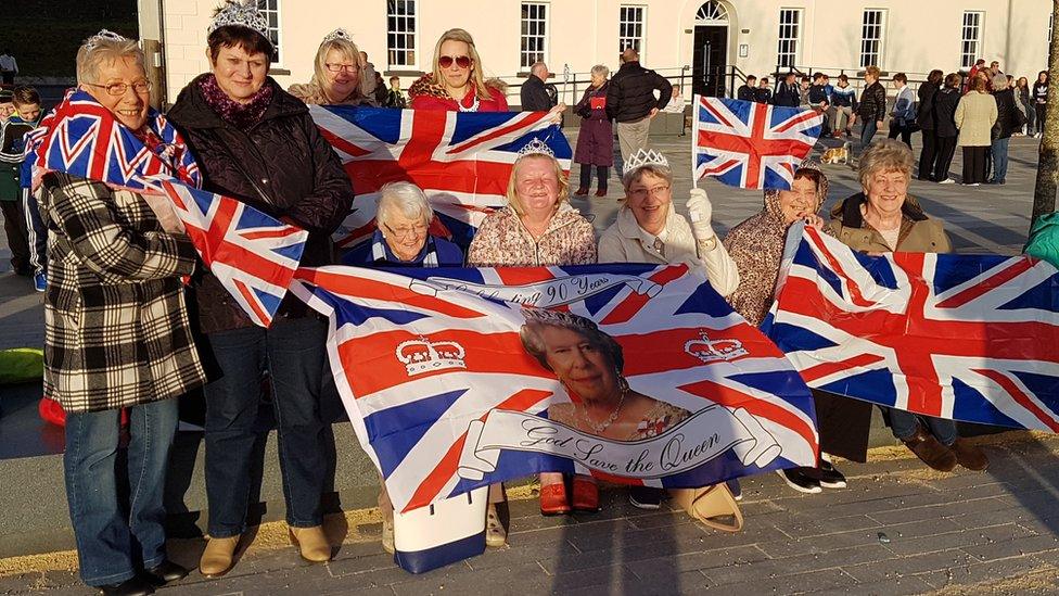 Fans of the Queen wear Union flags in Ebrington Square in Londonderry