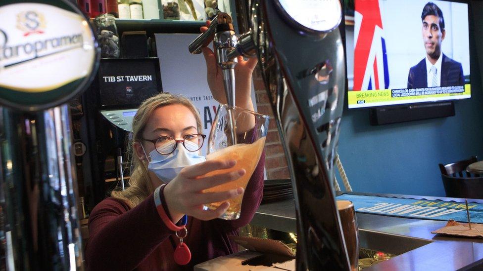 An employee pulls a pint in the Tib Street Tavern in Manchester