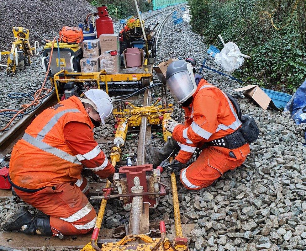 Engineers working on installing the track