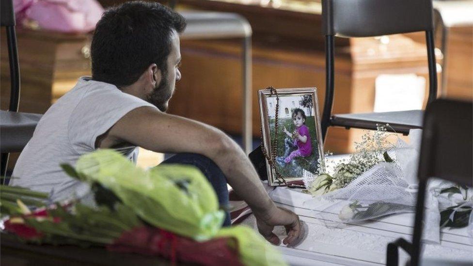 A man grieving in Italy before mass funerals for those killed in Wednesday's earthquake, 27 August 2016