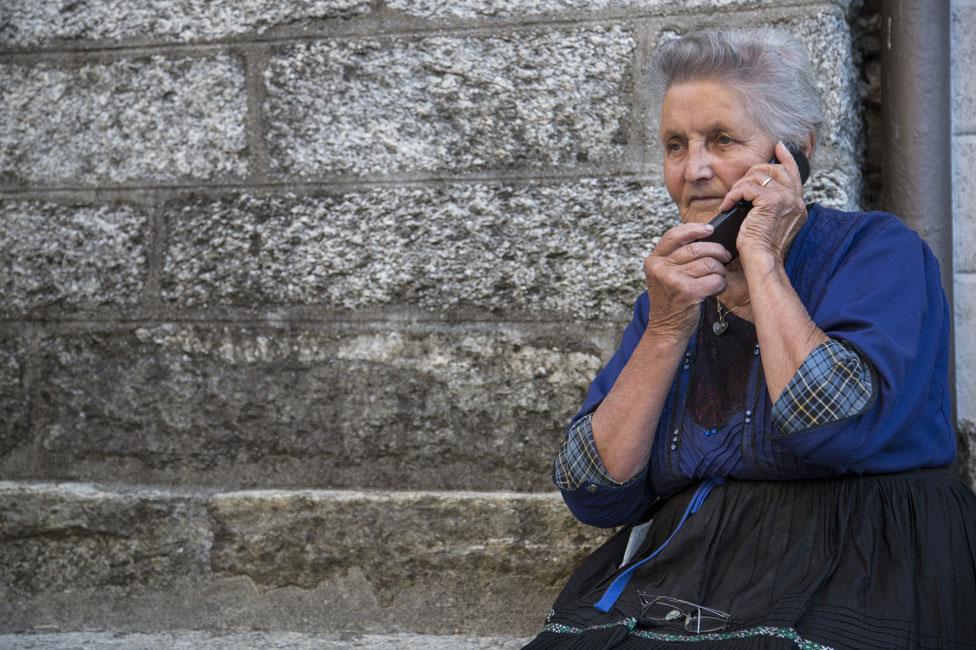 Woman on telephone, showing tartan cuffs